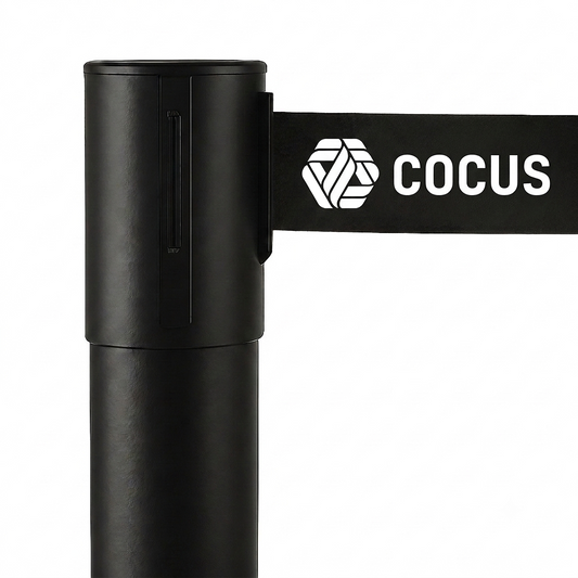 A close-up of a black retractable queue barrier pole with a black belt displaying the white Cocus logo and text, set against a plain white background.