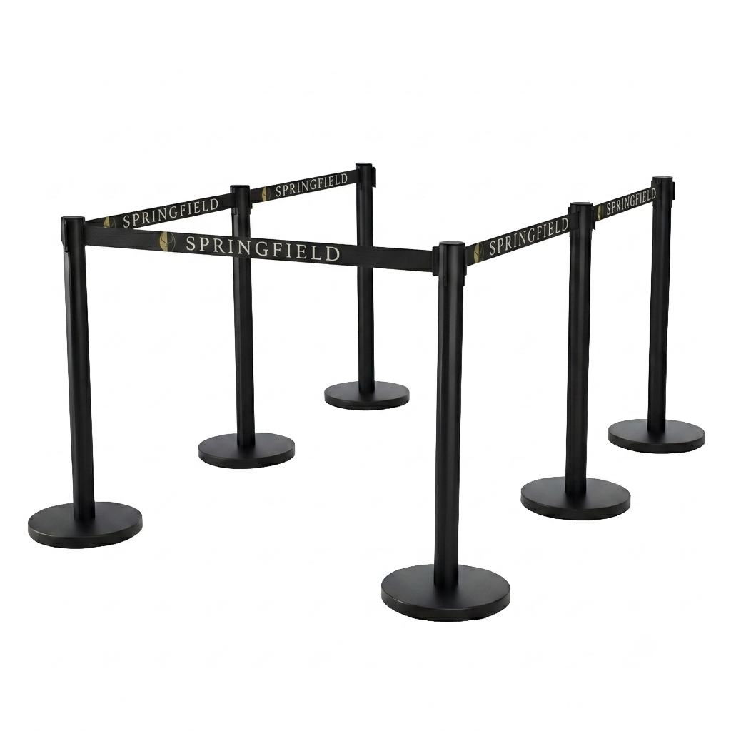 A set of black retractable queue barriers with gold 'SPRINGFIELD' branding on the belts, shown on a solid white background.